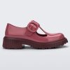 Side view of a Burgundy Mini Melissa Jackie loafer with a Burgundy base, two cut outs, a Burgundy buckle detail strap and brown sole.