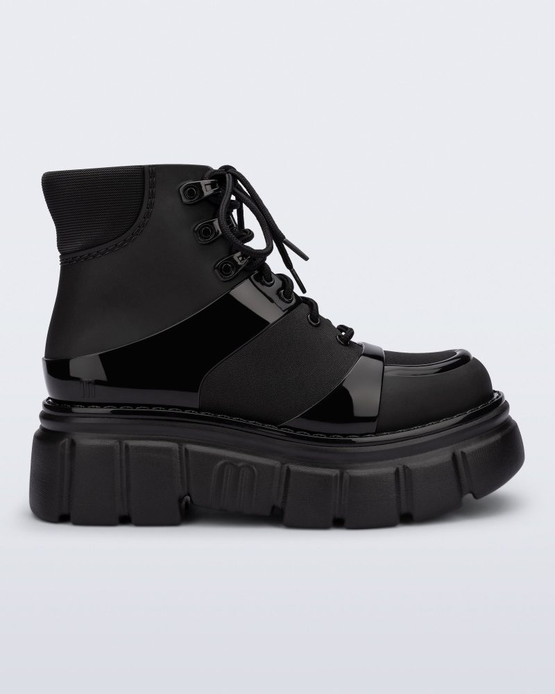 Side view of a black Rebel boot with laces