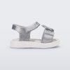 Side view of a white/glitter silver Mini Melissa Jump sandal with a Mickey Mouse logo detail on the front strap and an ankle strap