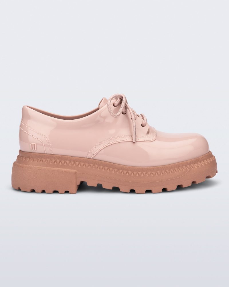 Side view of a pink with brown sole Charlotte adult sneaker loafer with laces