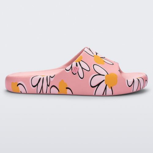 Side view of a pink Free Print slide with daisy print flowers