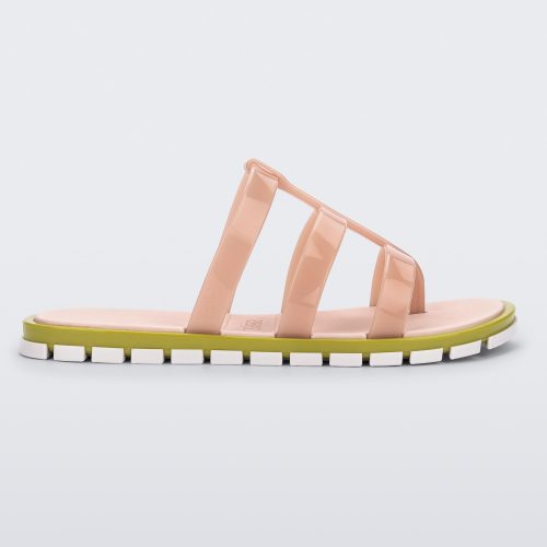 Side view of a pink Path adult sandal with  green sole