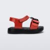 Side view of a red/black Mini Melissa Jump sandal with a black Mickey Mouse logo detail on the front red strap and a red ankle strap