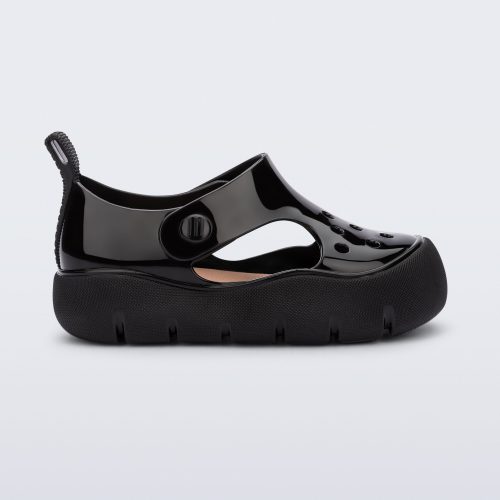 Side view of a black Bowie baby sandal.