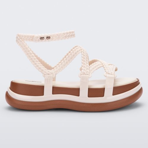 Side view of a beige Melissa Buzios platform sandal with multiple textured straps that mimic sisal braids across the front of the shoe as well as an ankle strap