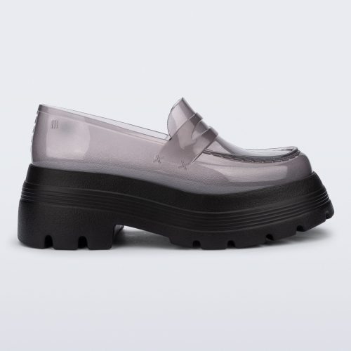 Side view of a transparent smoke Royal High + Undercover platform loafer with black sole.