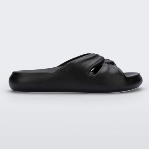 Side view of a black Melissa Free Slide with a twist front detail.