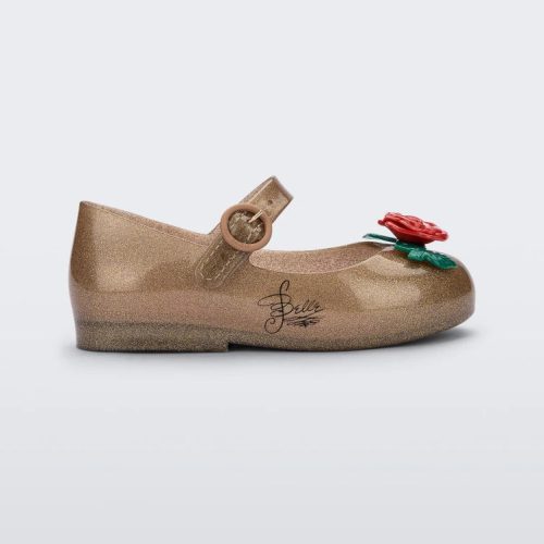 Side view of a gold/red Mini Melissa Sweet Love Princess flat with a gold base with Belle in script on the side, a top strap, a rose detail on the toe and a drawing of Belle of Beauty and the Beast on the insole.