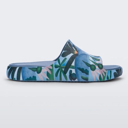 Side view of a blue multicolor Melissa Cloud slide with an abstract painting design of plants, water and lagoon.