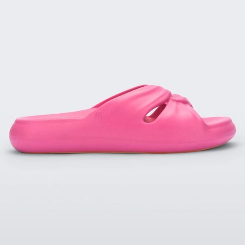 Side view of a pink Melissa Free Slide with a twist front detail.