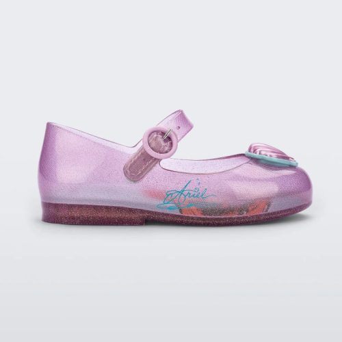 Side view of a pink Mini Melissa Sweet Love Princess flat, with a pink base, a top strap, Ariel in script on the side, a shell detail on the toe, and a drawing of Ariel of The Little Mermaid on the insole.