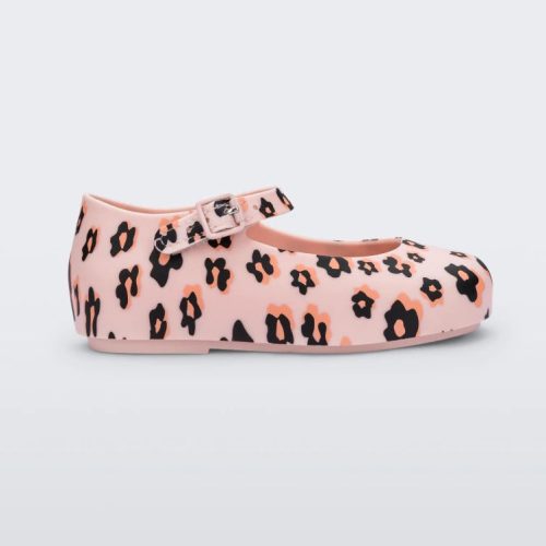 Side view of a Mini Melissa beige / black Dora flat with black and orange flower print.