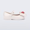 Side view of a white Sweet Love Snow White baby flat with a white bow with red apple center