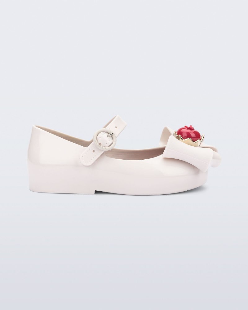 Side view of a white Sweet Love Snow White baby flat with a white bow with red apple center