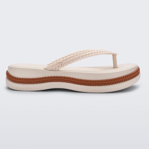 Side view of a beige/brown Melissa Leblon platform flip flop with details that mimic sisal braids on the sole and strap