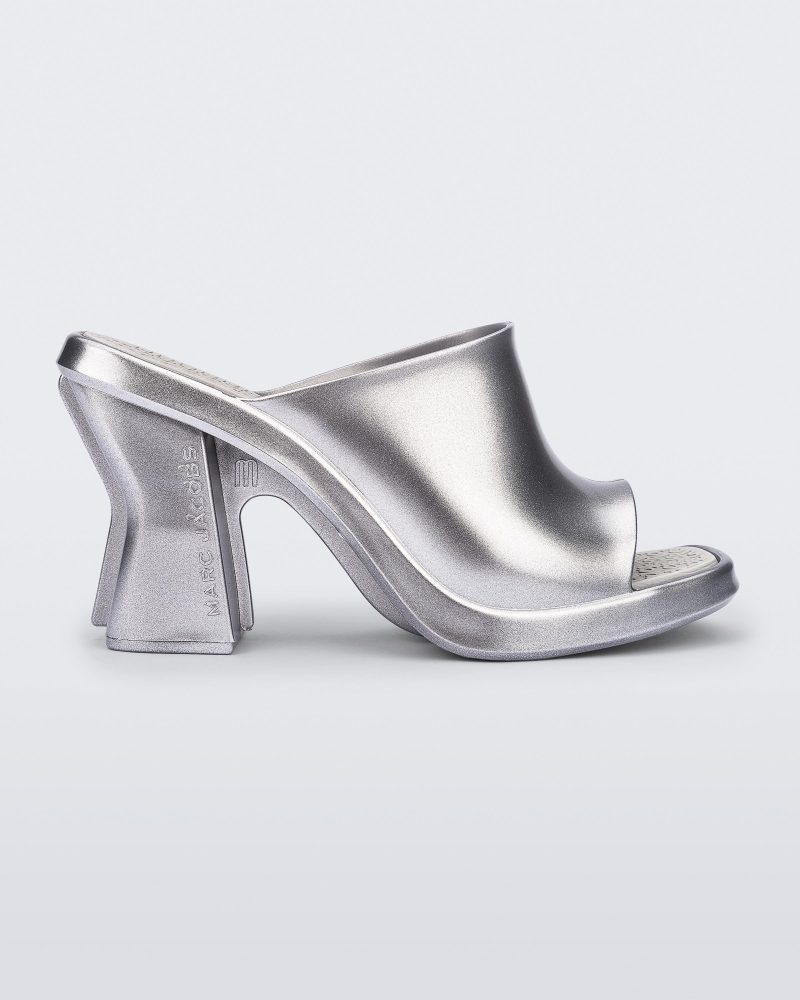 Side view of a silver Mule + Marc Jacobs heel