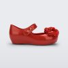 Side view of a red Ultragirl Springtime baby flat with two red flowers and peep toe.