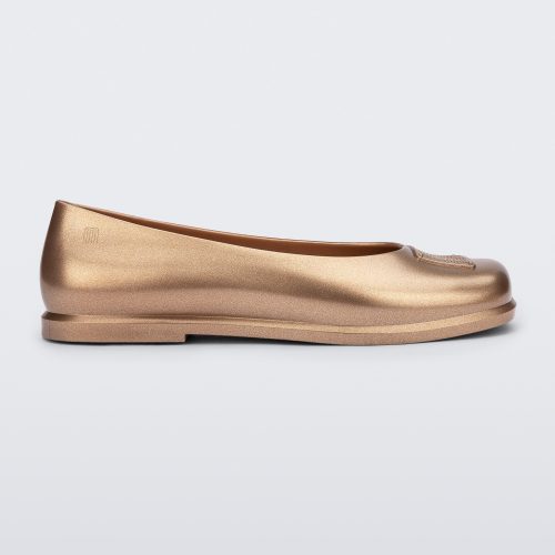 Side view of a metallic gold Ruby + Marc Jacobs flat