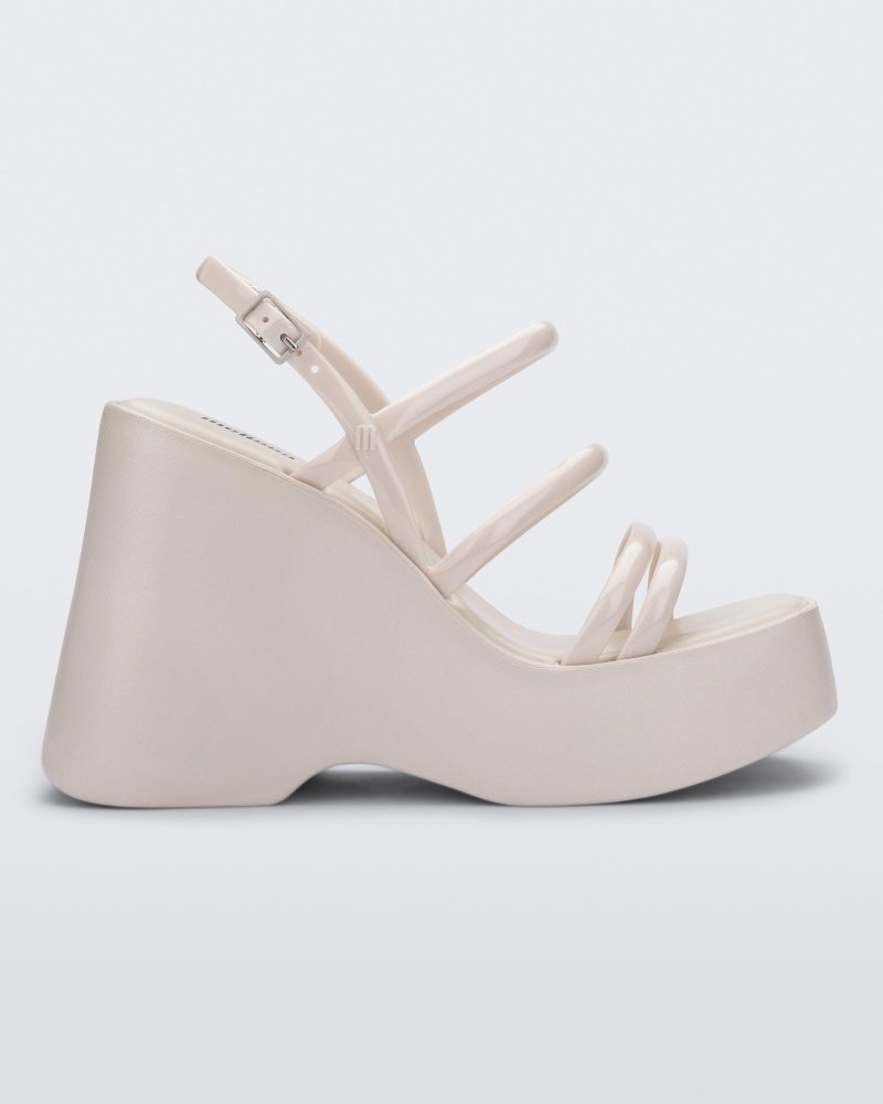 Side view of a white Jessie platform wedge sandal with side buckle ankle strap