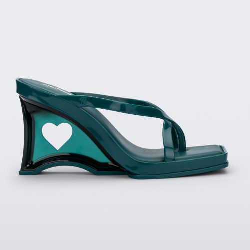 Side view of a green Glass Heel with a heart cutout in the heel.