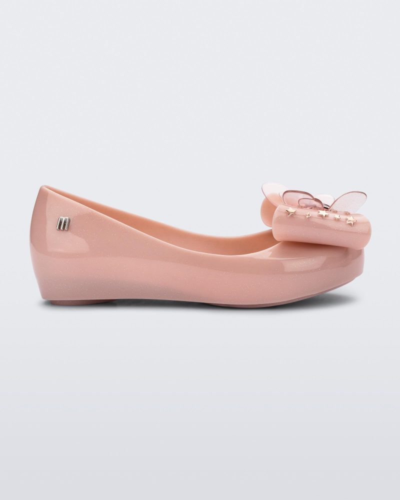 Side view of a Mini Melissa Ultragirl peeptoe ballet flat in pink with star printed butterfly bow applique.