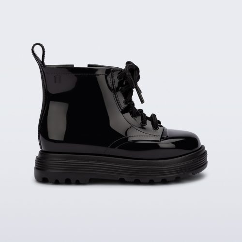 Side view of a black Coturno baby boot with black laces.