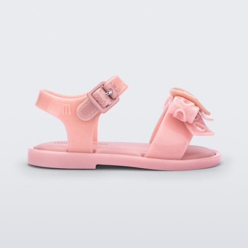 Side view of a glitter pink Mini Melissa Mar Sandal Heart sandal with a glitter pink heart bow detail on the front strap and an ankle strap