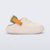 Side view of a beige with orange and green back strap Charlie baby sneaker