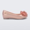 Side view of a pearly pink Ultragirl Springtime kids flat with two clear pink flowers and peep toe.