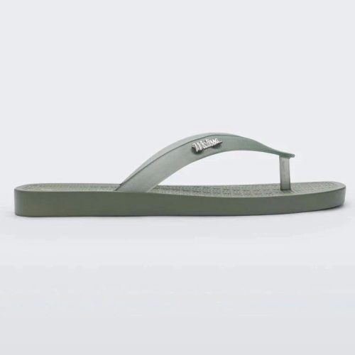 Side view of green/clear Melissa Sun Long Beach flip flop with a green base and clear green straps with "melissa" on the strap.