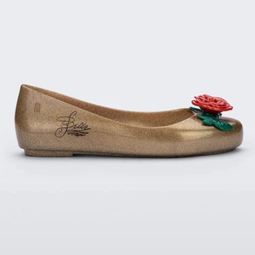 Side view of a gold Mini Melissa Sweet Love Princess flat, with a gold base, Belle in script on the side, a rose detail on the toe, and a drawing of Belle of Beauty and the Beast on the sole.