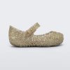 Side view of Mini Melissa Campana gold flats with a snap strap for baby.