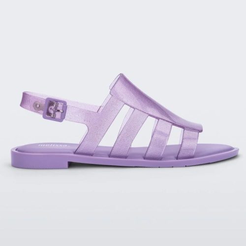 Side view of a transparent lilac glitter Melissa Boemia sandals with straps conjoining in the front and a back buckle.