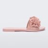 Side view of a light pink Melissa Babe Garden slide with two flowers on the front strap.