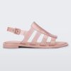 Side view of a transparent glitter pink Melissa Boemia sandal with straps conjoining in the front and a back buckle.