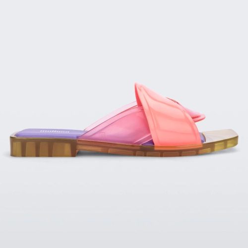 Side view of a pink/green/lilac Melissa Brigitte slide with a pink weft designed upper strap and purple and green insole.