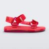 Side view of a pair of red Melissa Papete sandals.