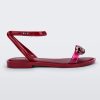 Side view of a red Melissa Dare sandal with a red metal chain buckle.