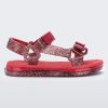 Side view of a red and glitter Mini Melissa Papete sandal.