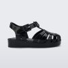 An outter side view of a black Mini Melissa Possession sandal with several straps with a closed toe front.