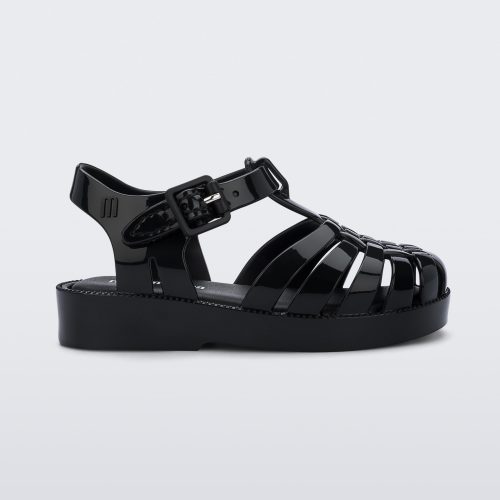 An outter side view of a black Mini Melissa Possession sandal with several straps with a closed toe front.