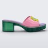 Side view of a Melissa Shape slide with green platform heel,  a pink wide front strap with a yellow and blue flower on the top of the strap and a purple insole