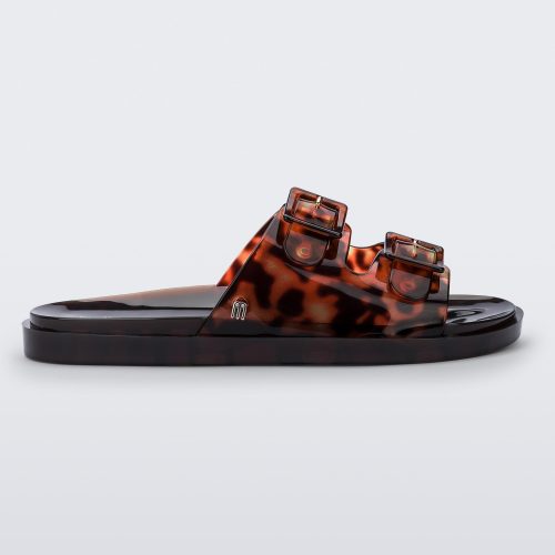 Side view of a Melissa Wide slide sandal with brown sole and  Brown Tortoise colored straps