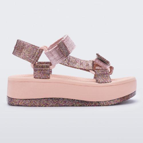 An outter side view of a pink Melissa Papete Platform sandal with glitter straps and a pink and glitter sole.