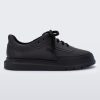 Side view of a matte black Melissa Classic sneaker with a black base, laces, sole and a melissa logo on the side.