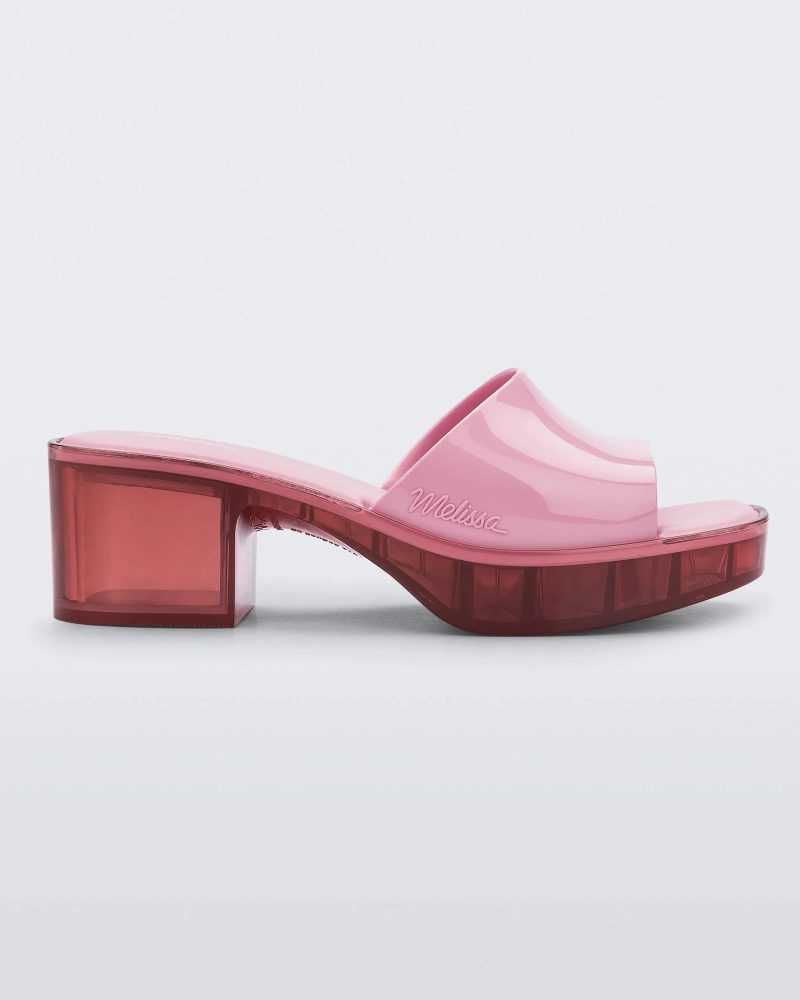 Side view of a Melissa Shape slide with transparent pink platform heel and a pink wide front strap.