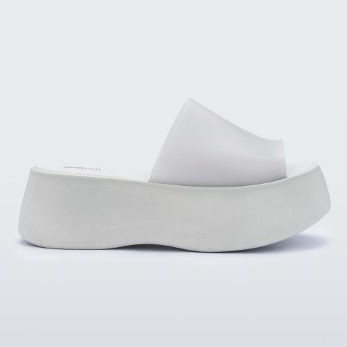 Side view of a white Melissa Becky platform slide. 