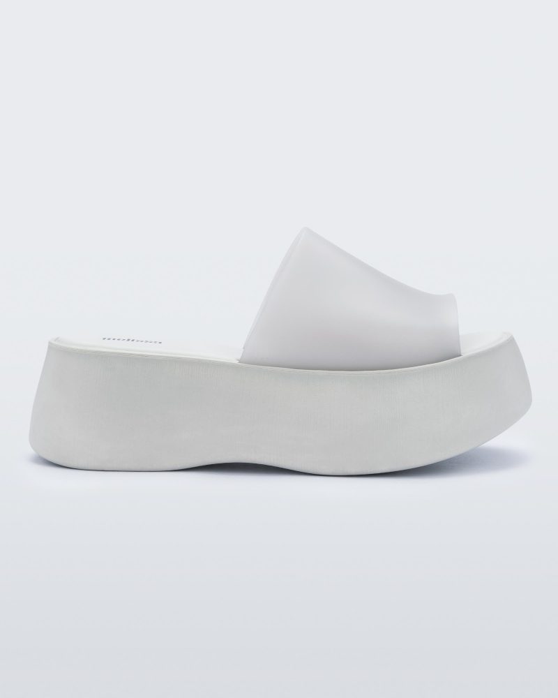 Side view of a white Melissa Becky platform slide.