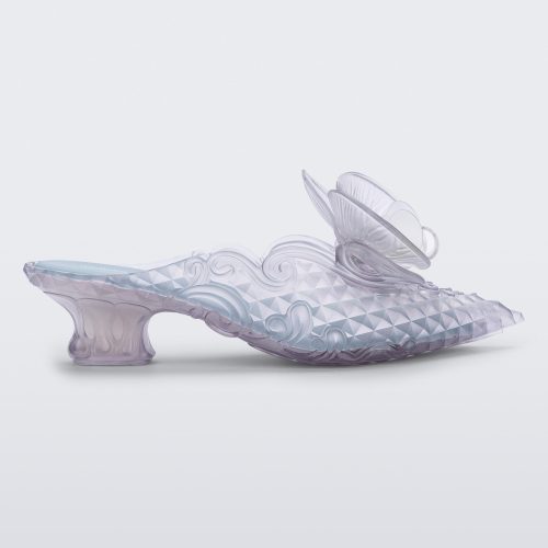 SIde view of a Melissa Flower Court mule in clear with kitten heel and a 3D flower above the toe