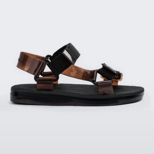 Side view of a pair of black Melissa Papete sandals with black and transparent brown straps.